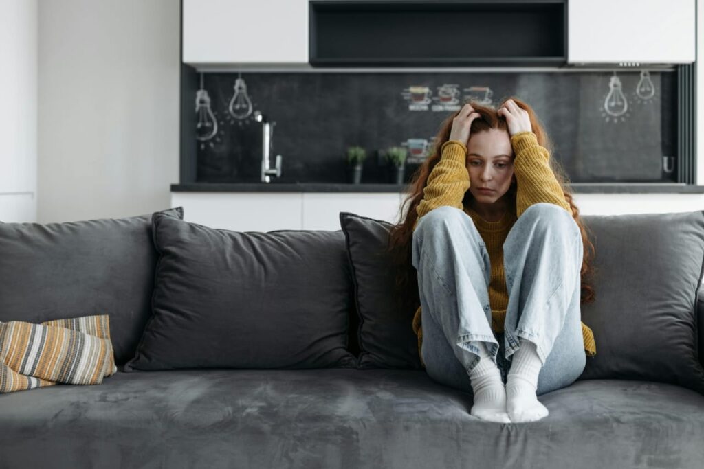 woman is depressed , sitting alone due to relationship issues and declining interest towards her.